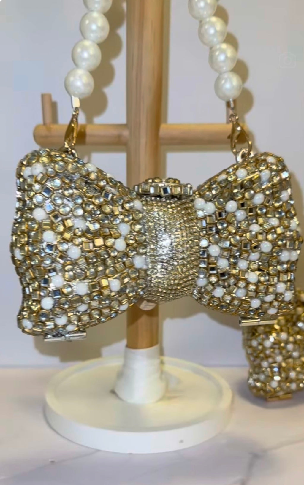 Bow kundan and pearl clutch