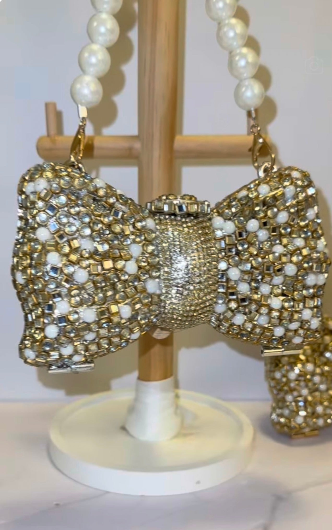 Bow kundan and pearl clutch