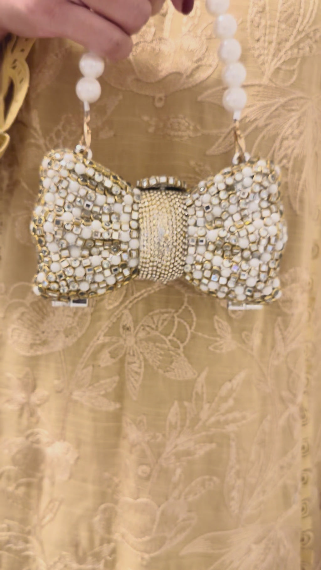 Bow kundan and pearl clutch